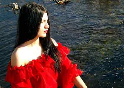 A photo of a Latina wearing a red blouse